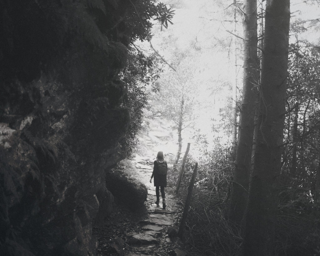 Rigel Hellas photograph of a woman exploring the woods. Be not afraid of what lies ahead!